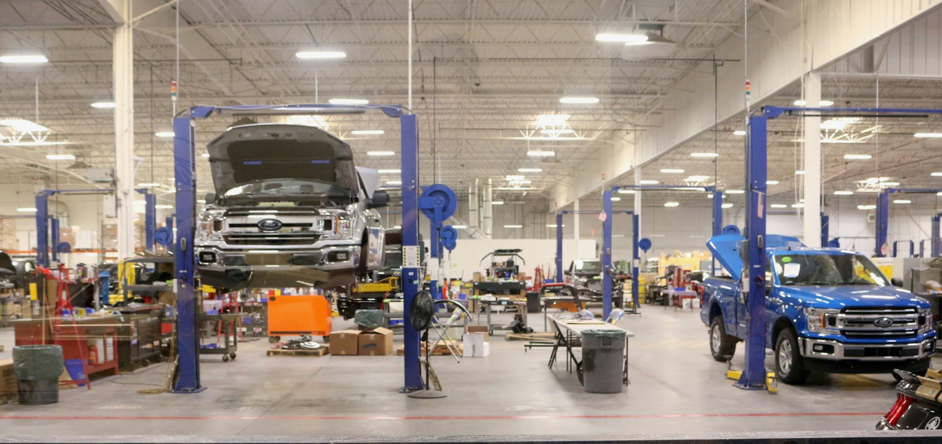 Skilled auto body technicians performing high-precision repairs at Network Auto Body's state-of-the-art facility.