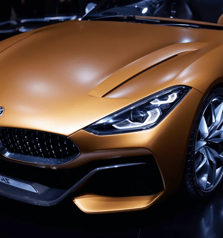Metallic bronze luxury car front end with a flawless finish, highlighting professional auto body paint restoration and color matching.